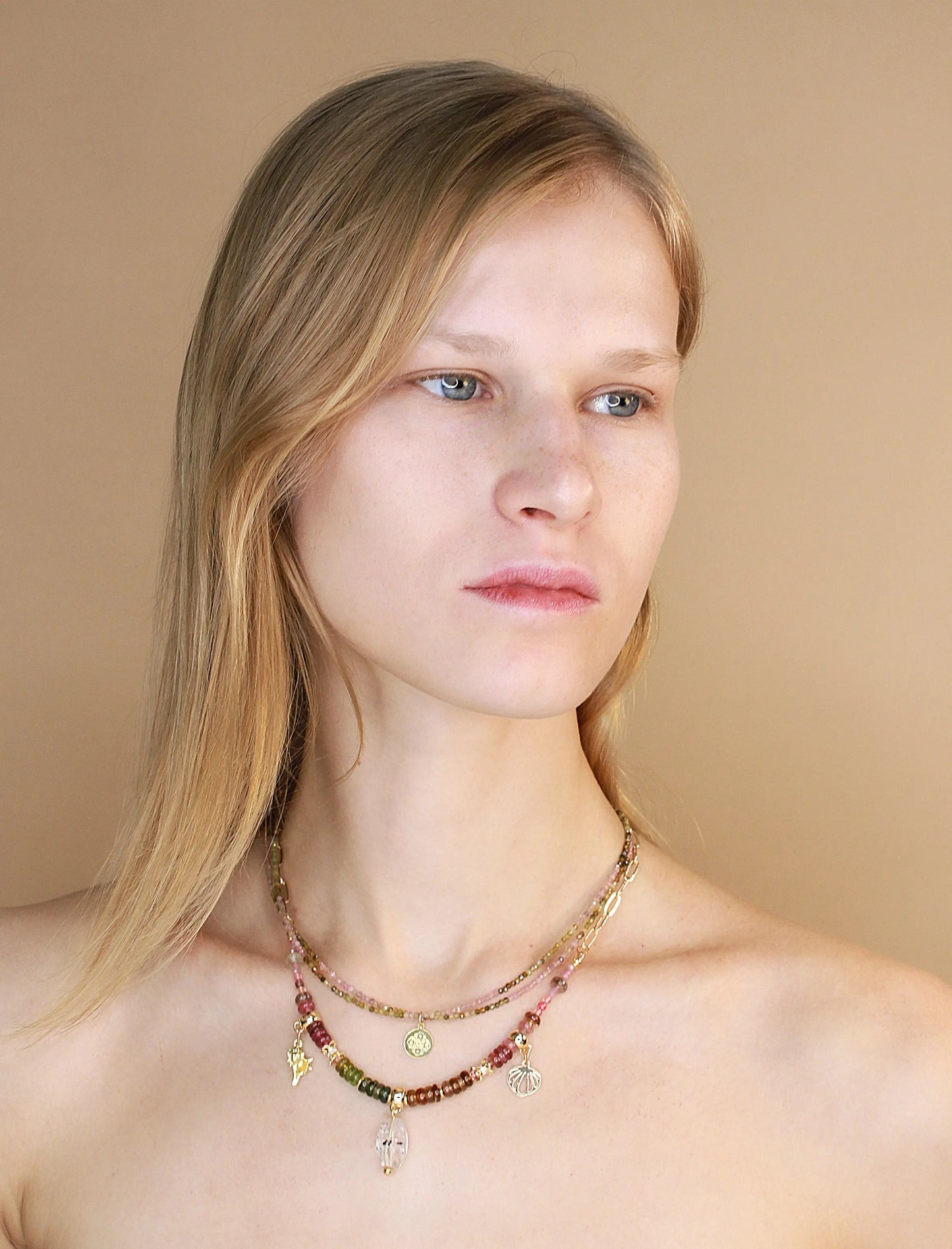 Female model wearing Herkimer diamond pendant and tourmaline stone necklace
