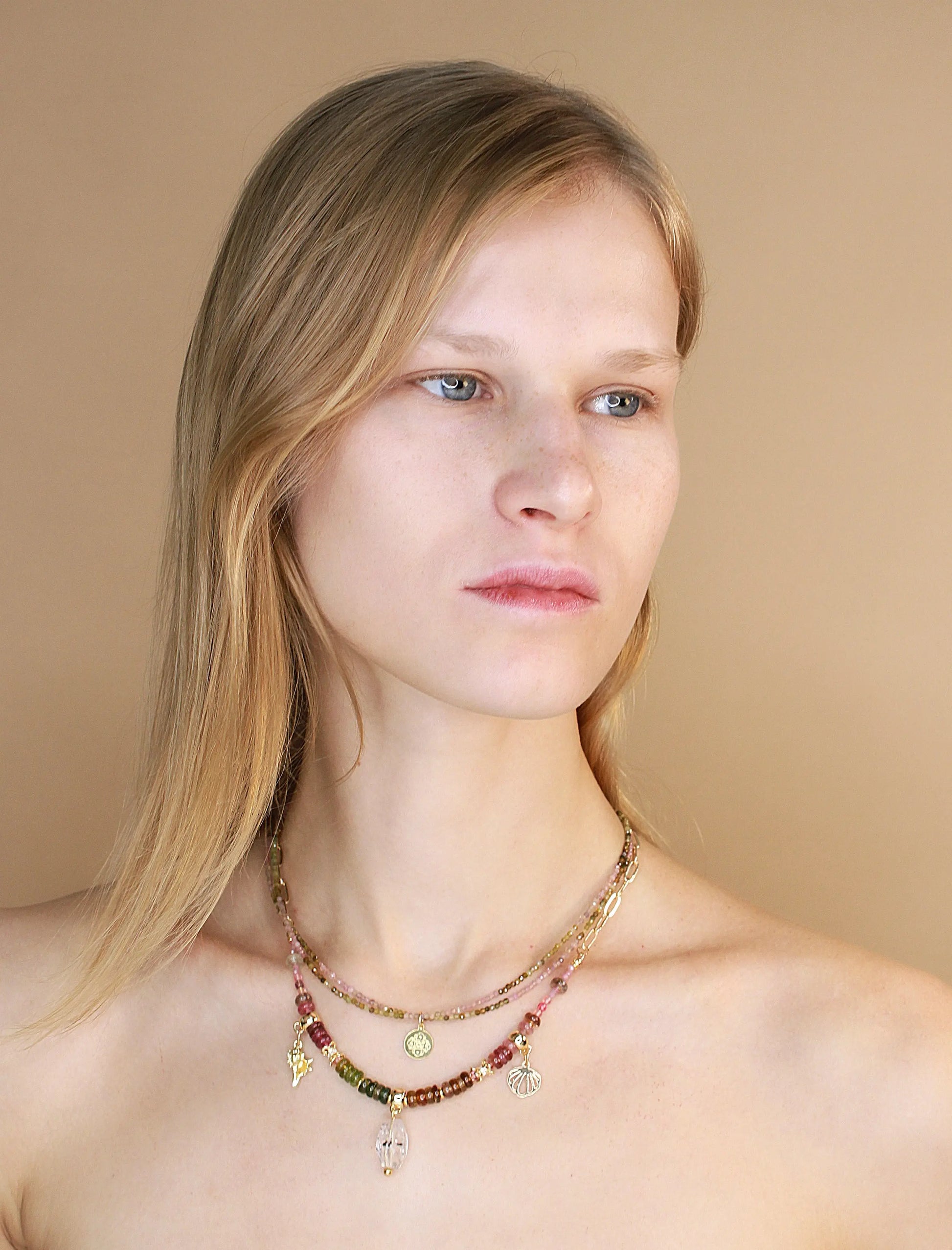 Female model wearing Herkimer diamond pendant and tourmaline stone necklace