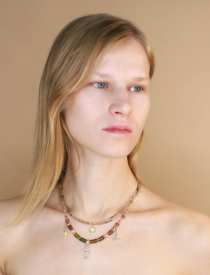 Female model wearing Herkimer diamond pendant and tourmaline stone necklace